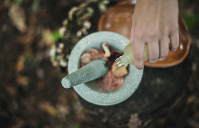A mortar and pestle with wholesale organic essential oil products for breathing.